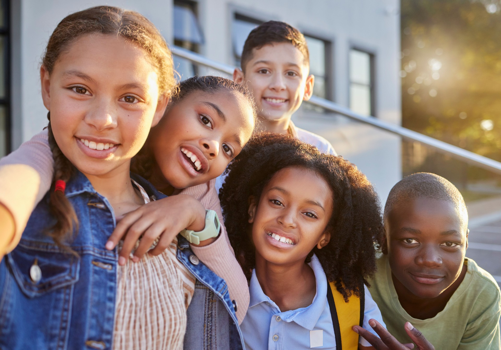 Friends, smile and selfie with children in school for teamwork, education and diversity. Support, scholarship and learning with portrait of group of students for happy, youth and collaboration