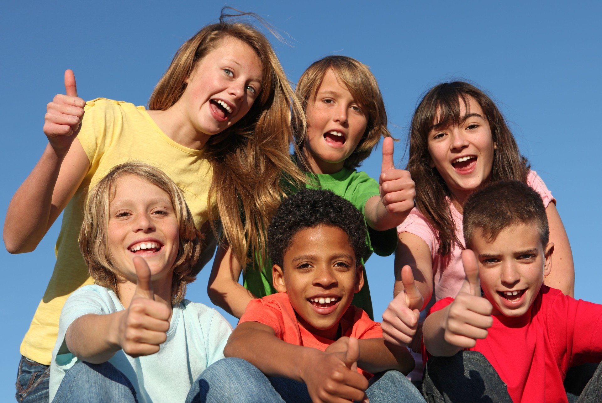 group of diverse kids holding thumbs up