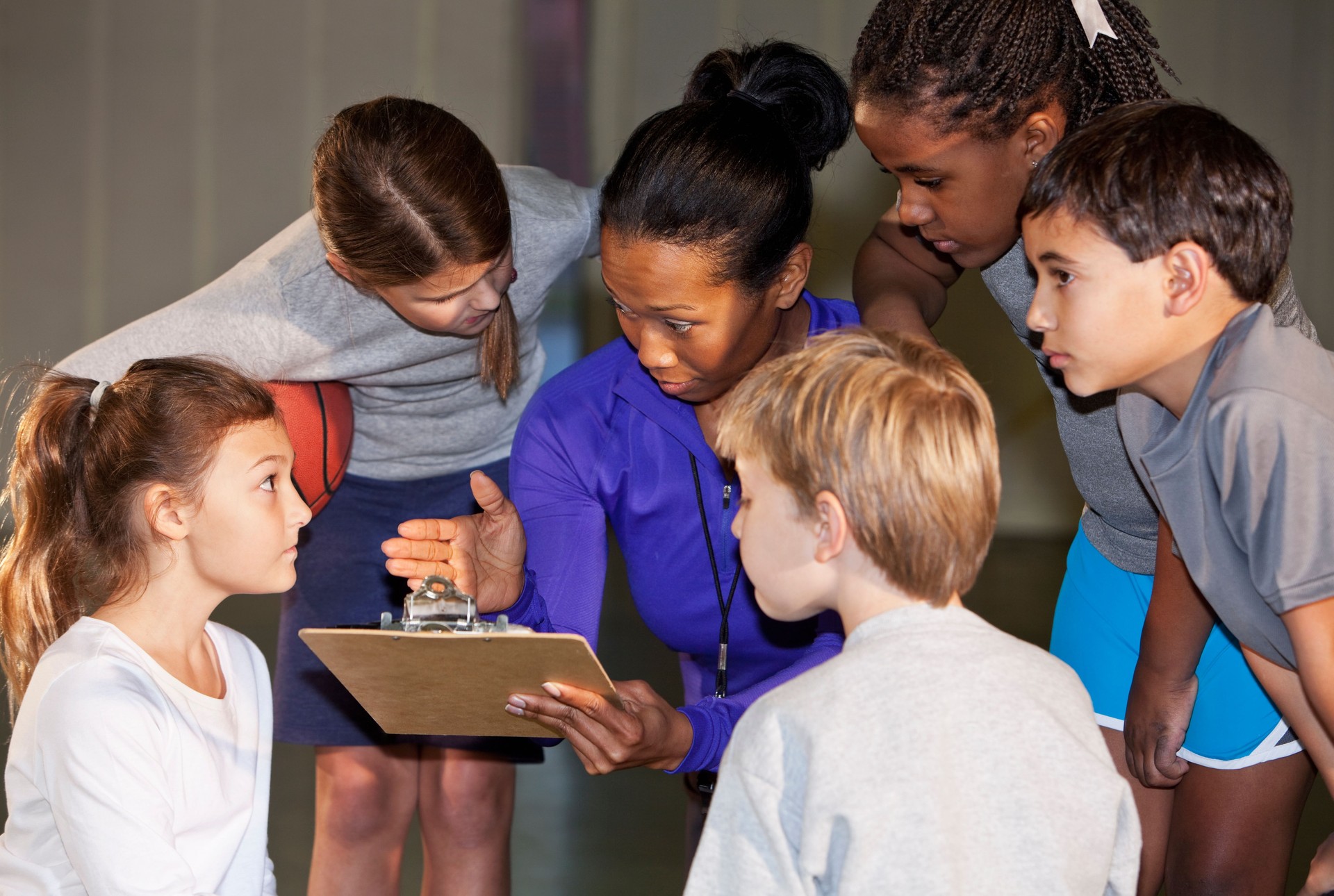 Children with basketball coach